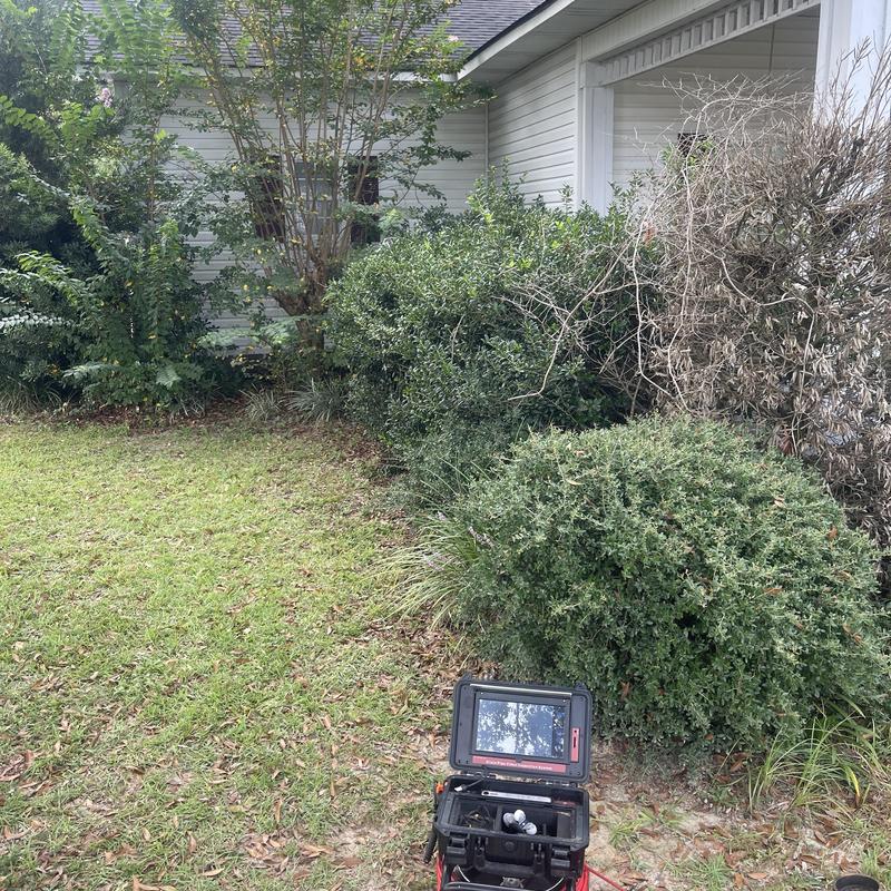 Mainline sewer camera inspection setup by house shrubs Mainline sewer camera inspection setup by house shrubs