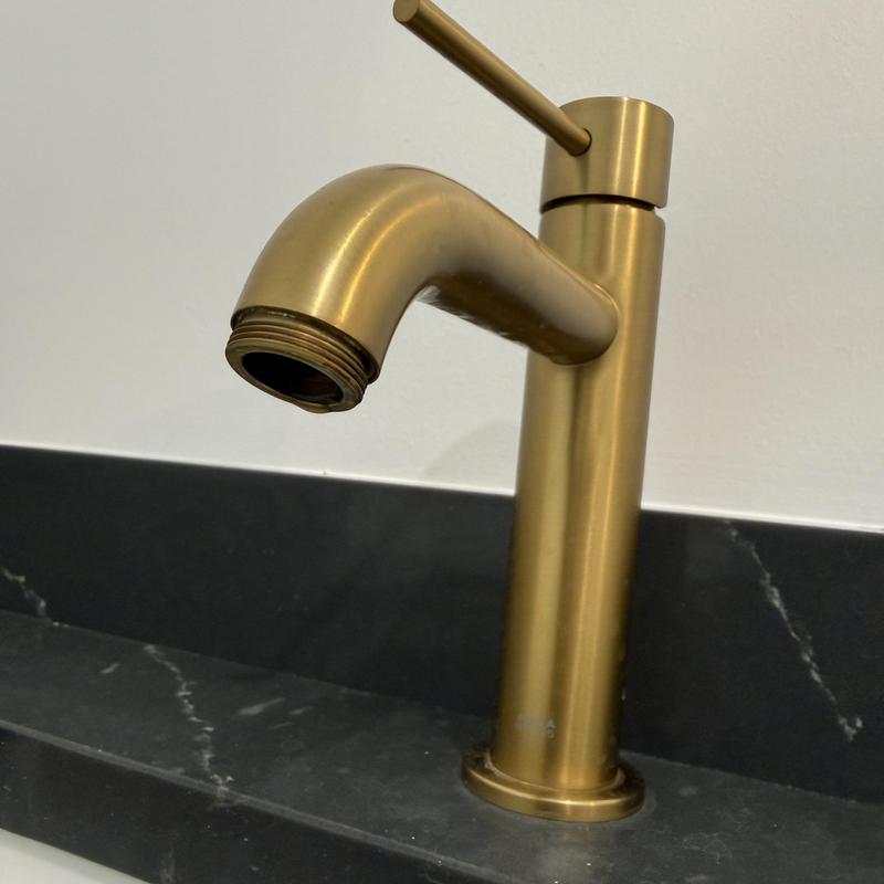 Brass bathroom faucet missing aerator on countertop Brass bathroom faucet missing aerator on countertop
