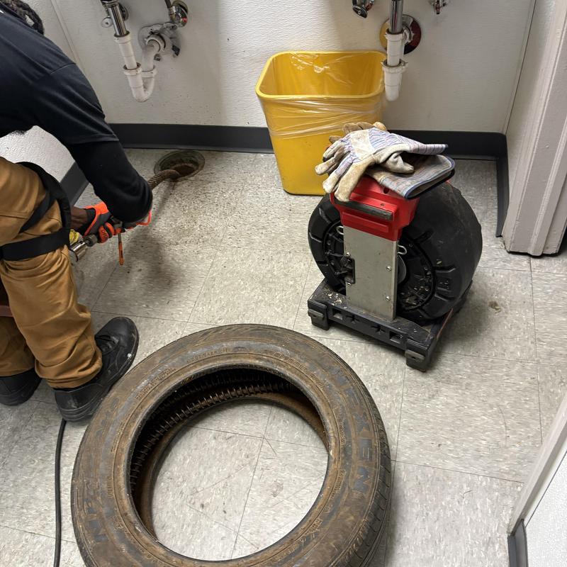 Main line drain snake with flex shaft and gloves nearby Main line drain snake with flex shaft and gloves nearby