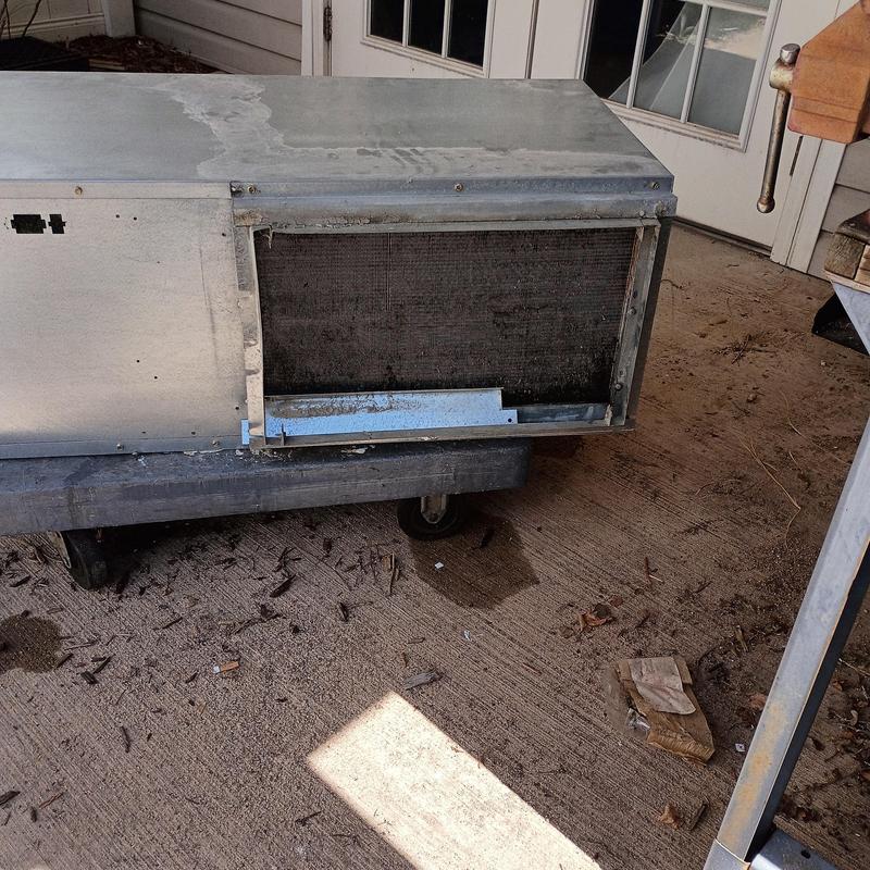 Heat pump unit cabinet removed on dolly outdoors Heat pump unit cabinet removed on dolly outdoors