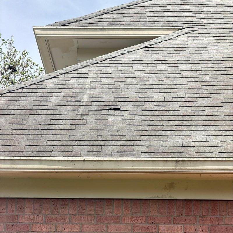 Roof shingles with visible hail damage and wear