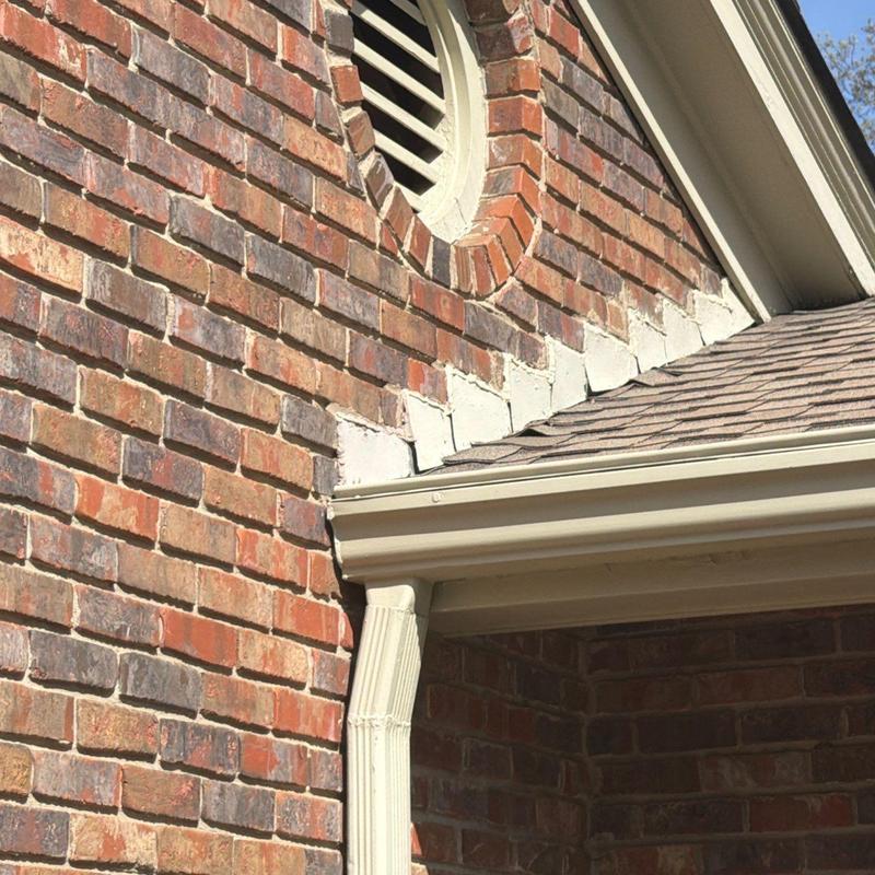 Brick wall and roof edge with gutter system