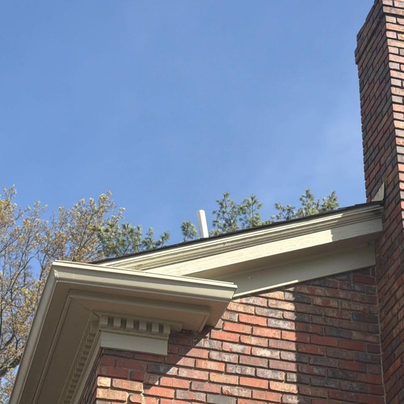 Roof edge and shingle inspection on brick house