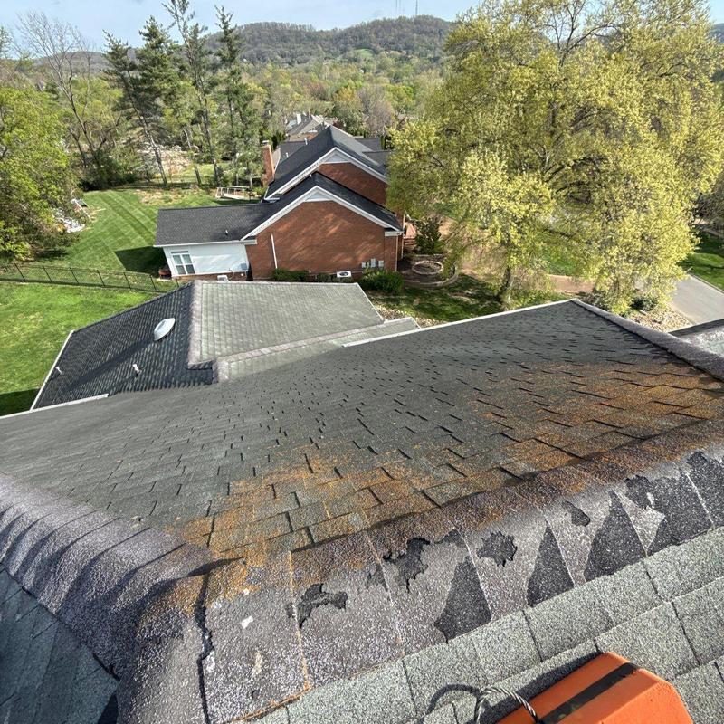 Asphalt shingle roof with hail and weather damage