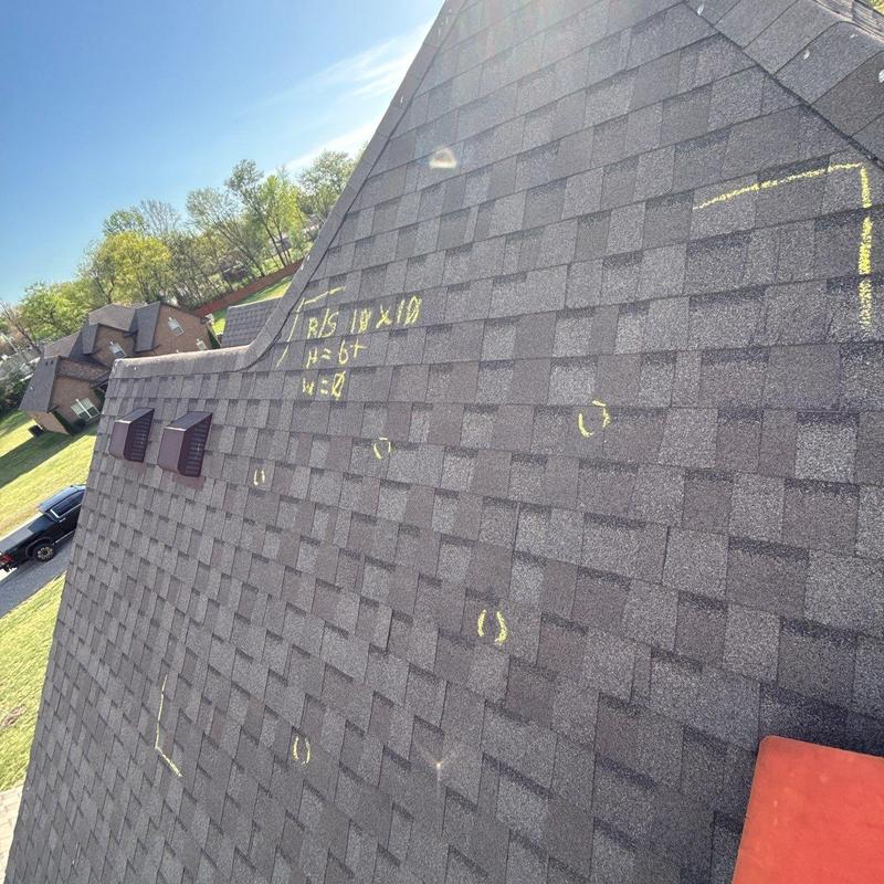 Asphalt shingle roof with hail damage markings
