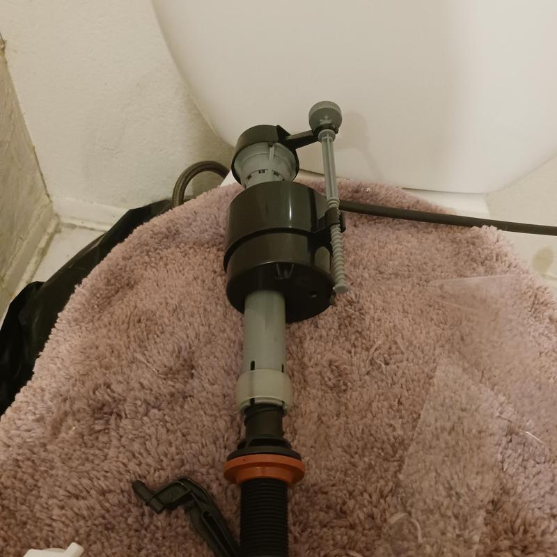 Toilet fill valve and flush assembly on towel surface Toilet fill valve and flush assembly on towel surface