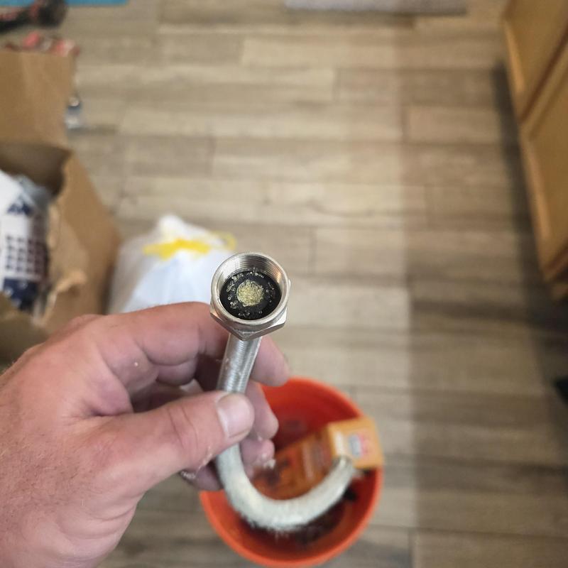 Water softener hose with clogged mineral buildup inside