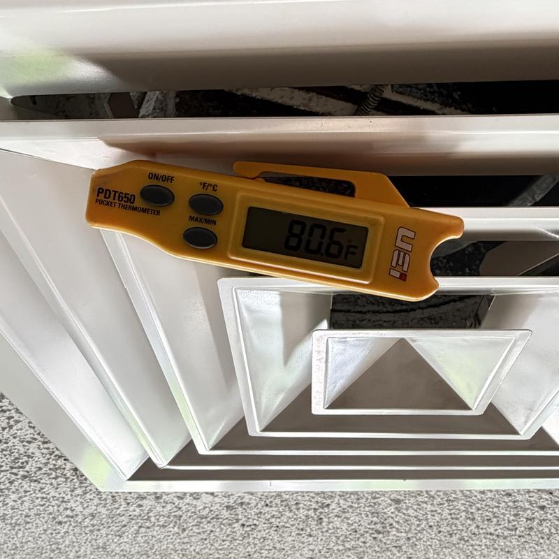 Air vent with thermometer reading 80.6°F in common area Air vent with thermometer reading 80.6°F in common area