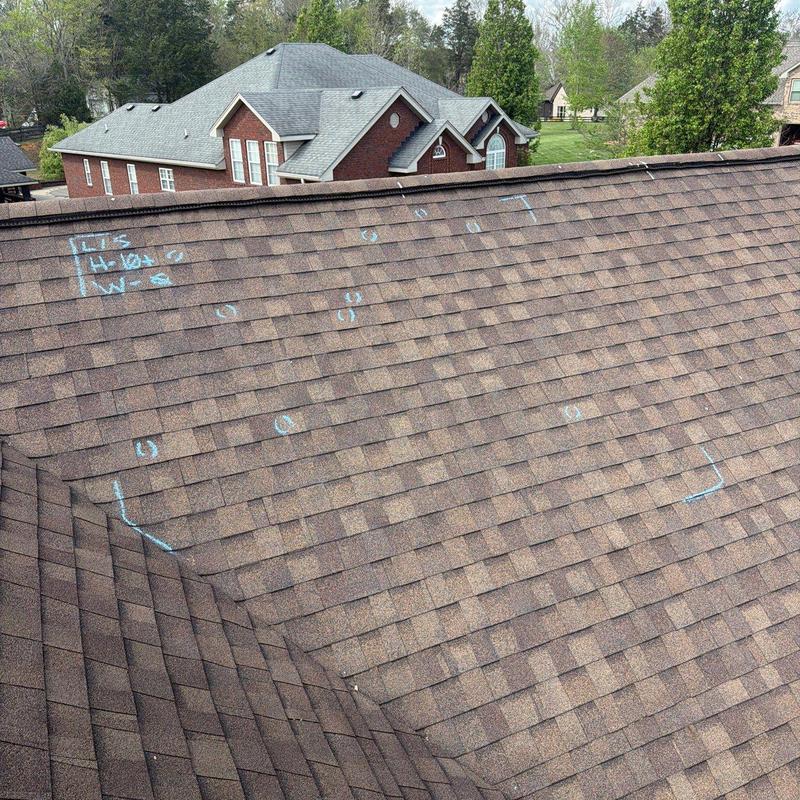 Asphalt shingle roof with hail damage markings