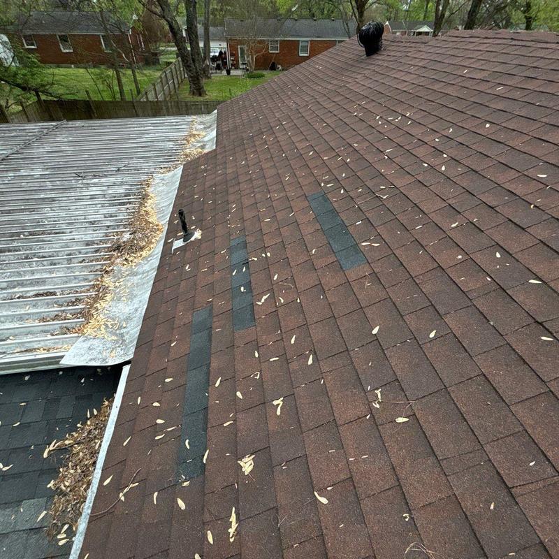 Asphalt shingles on roof with replacement patches