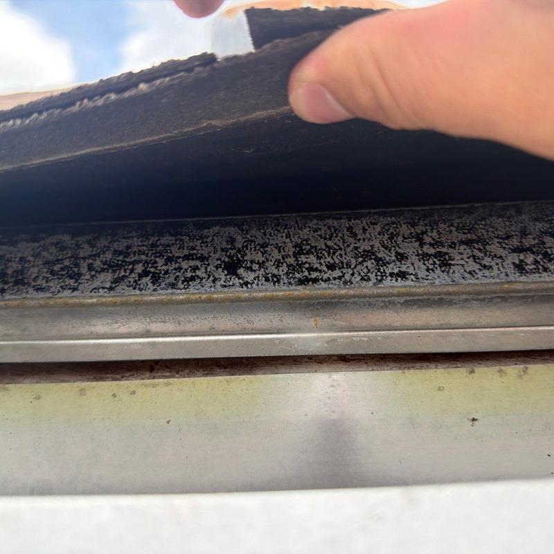 Roof flashing inspection showing wear and potential damage