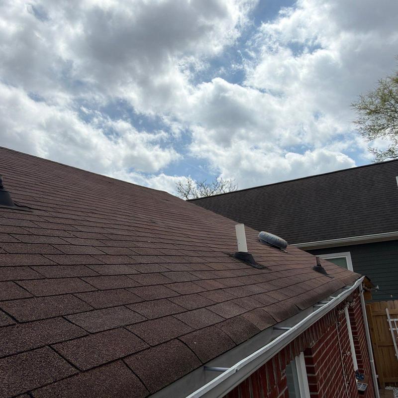 Asphalt shingle roof with ventilation pipes and gutters