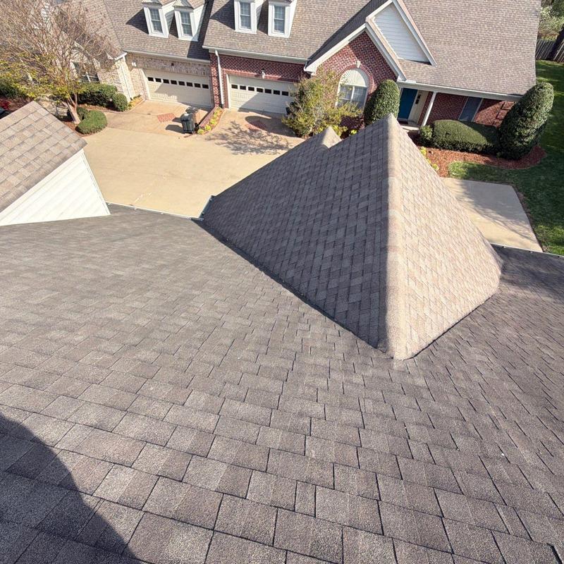 Asphalt shingle roof surface with visible dormer structure