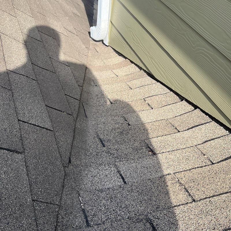 Roof shingles with visible hail impact and wear