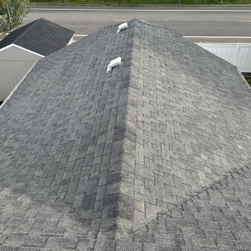 Asphalt shingle roof with vent pipes and ridge cap