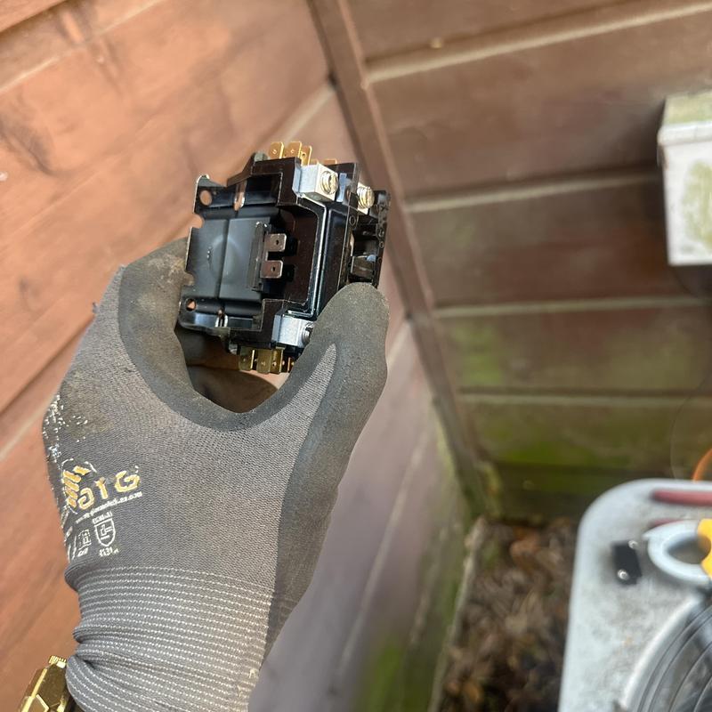 HVAC contactor held during surge protection installation HVAC contactor held during surge protection installation
