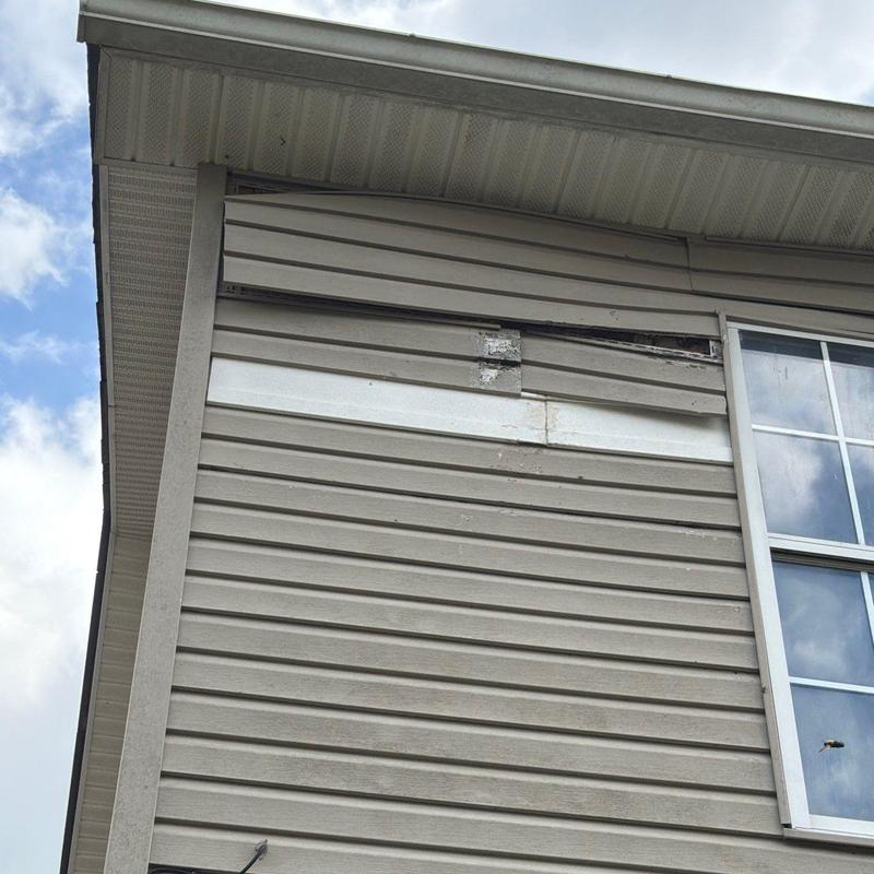Vinyl siding warping and damage near window panel