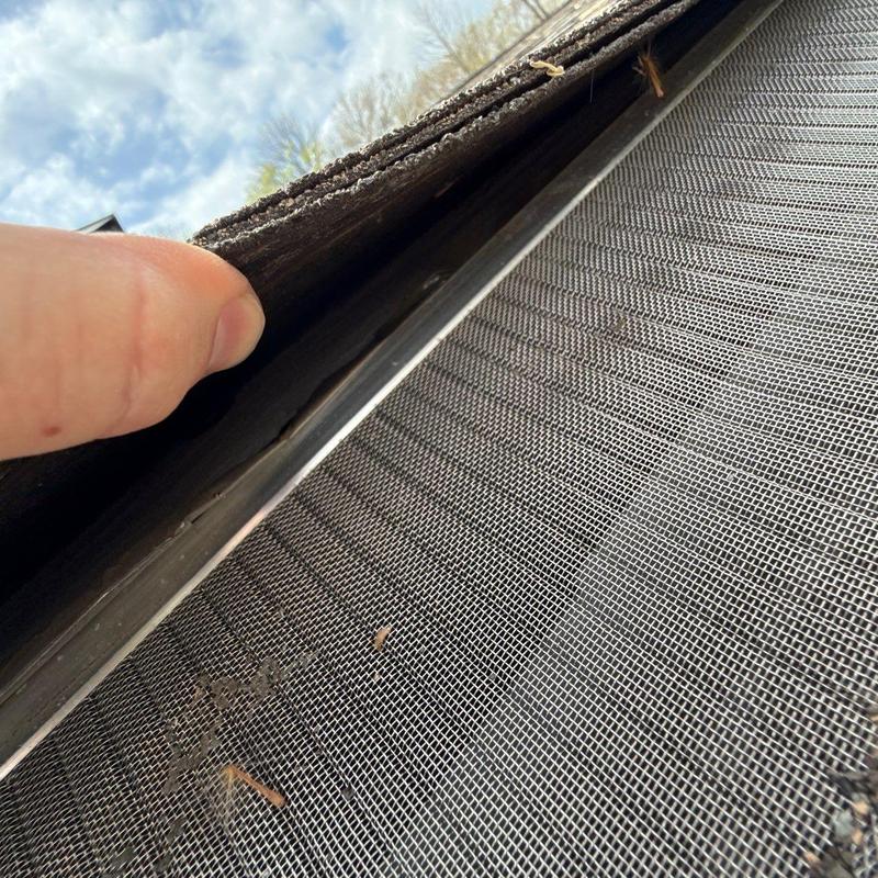 Roof shingles lifted to inspect flashing and screen