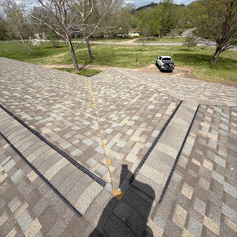 Asphalt shingles with hail damage on roof valley