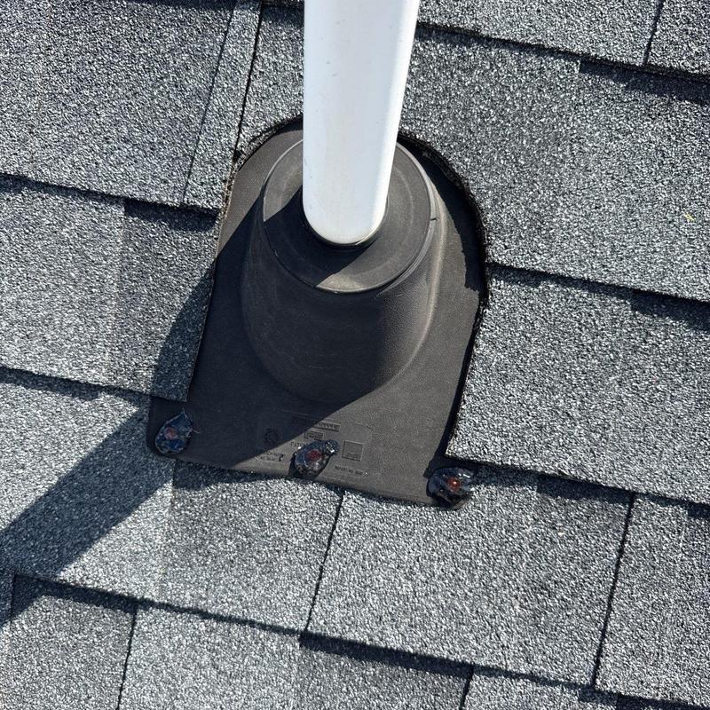 Roof pipe flashing on asphalt shingle roof with sealant