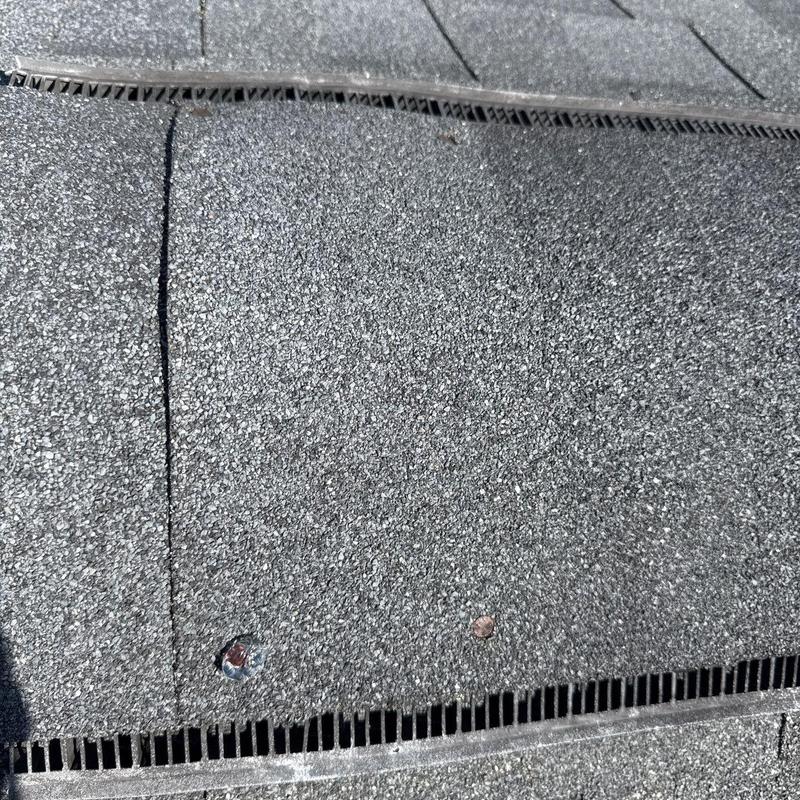 Roof shingles with visible hail impact damage