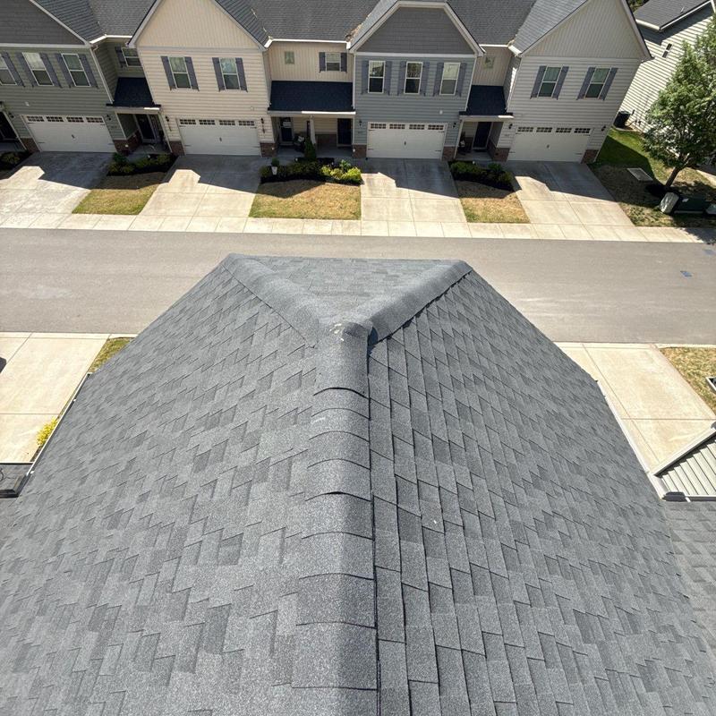 Asphalt shingle roof ridge with hail damage inspection