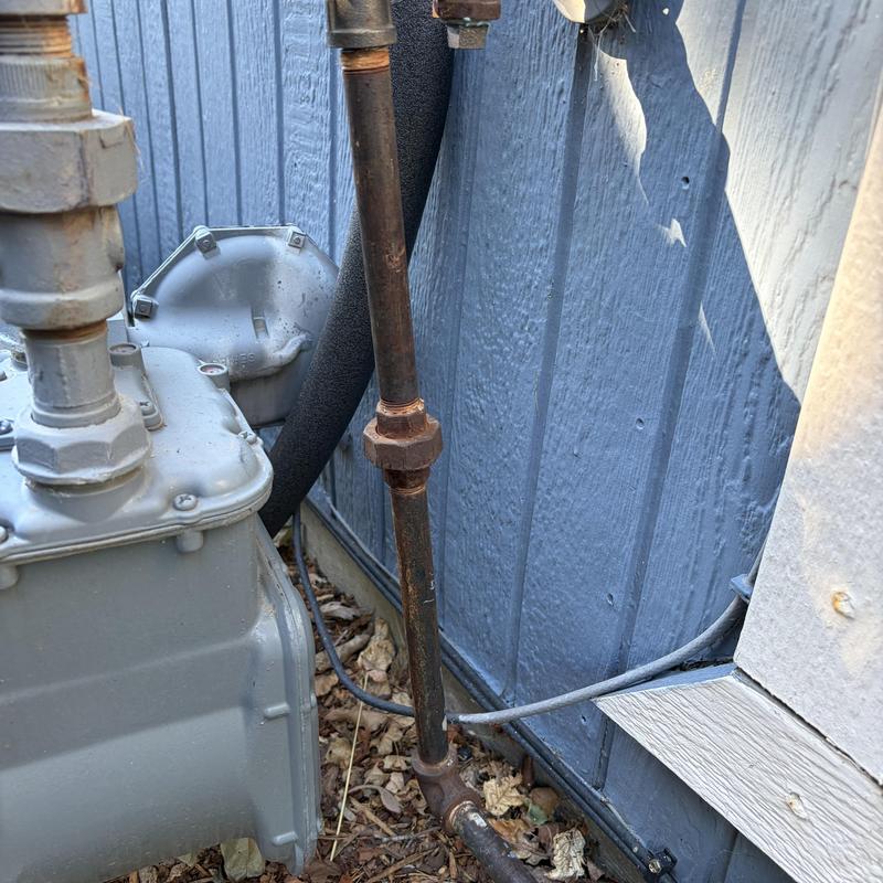 Fireplace gas valve and piping outside wall