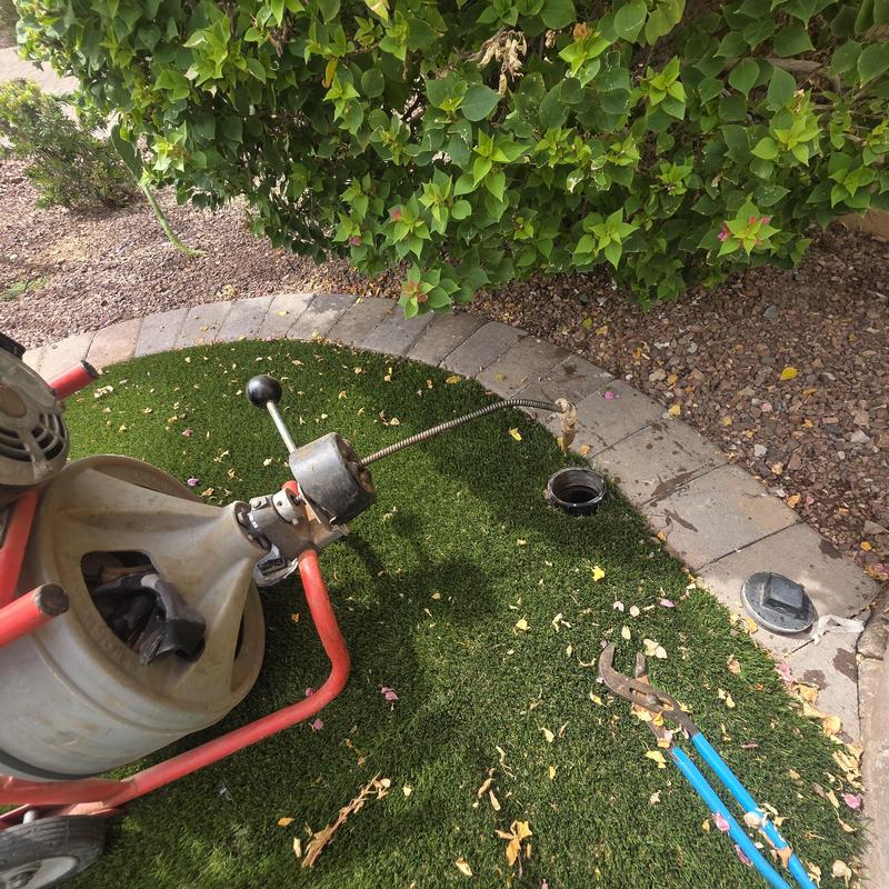 Sewer main cleaning machine with access point open