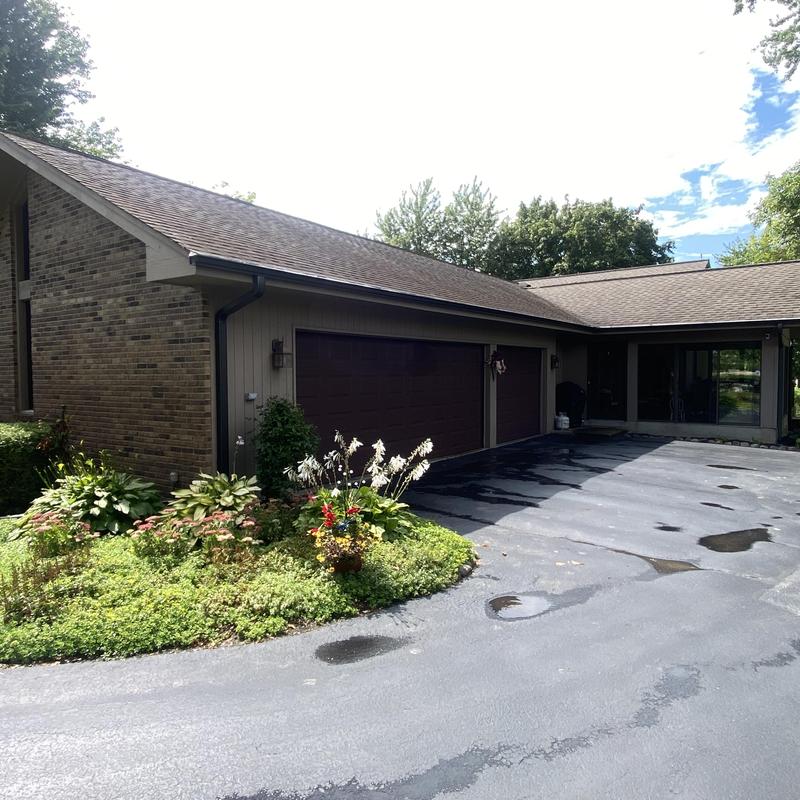 Gutters with gutter guards on residential home roof