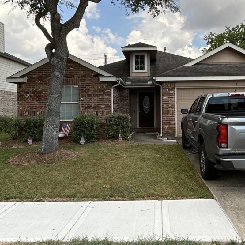 Architectural shingle roof with visible wear and damage