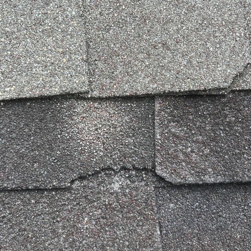 Architectural shingles showing damage and granule loss