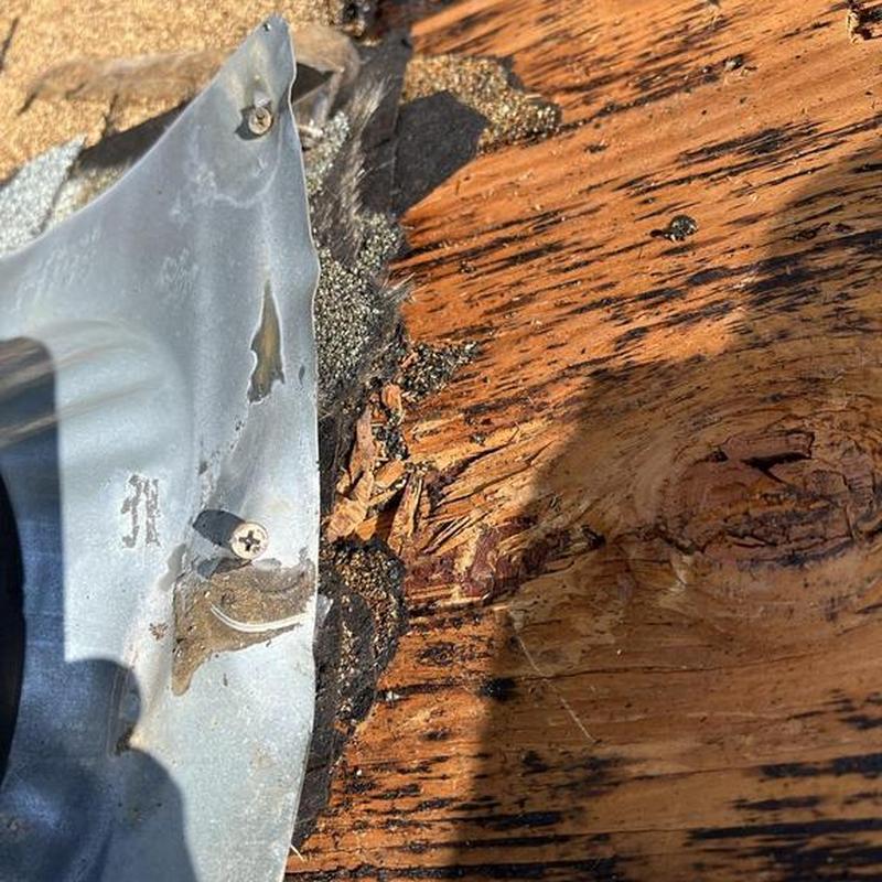 Roof plywood with dry rot and damaged flashing detail