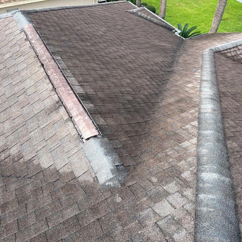 Shingle roof with metal ridge cap and valley flashing Shingle roof with metal ridge cap and valley flashing