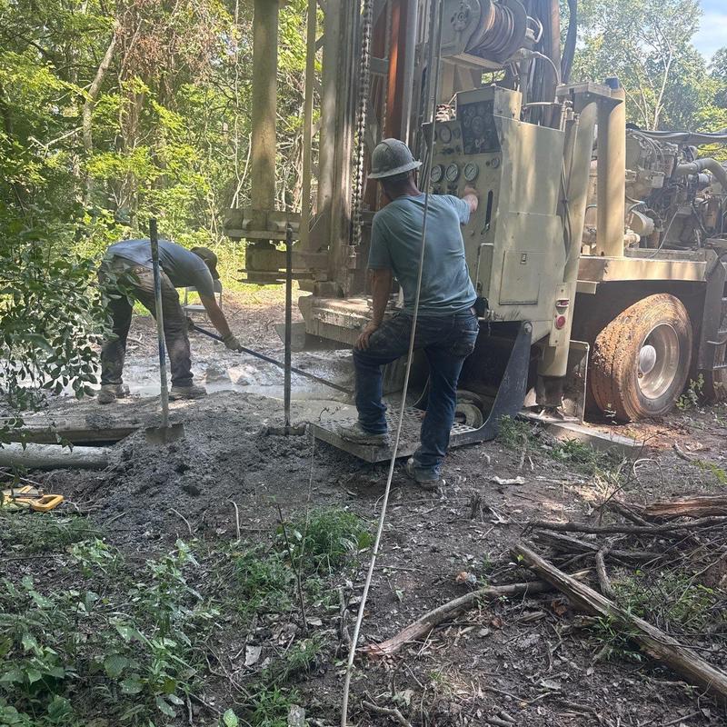 Well drilling rig operation and soil excavation site