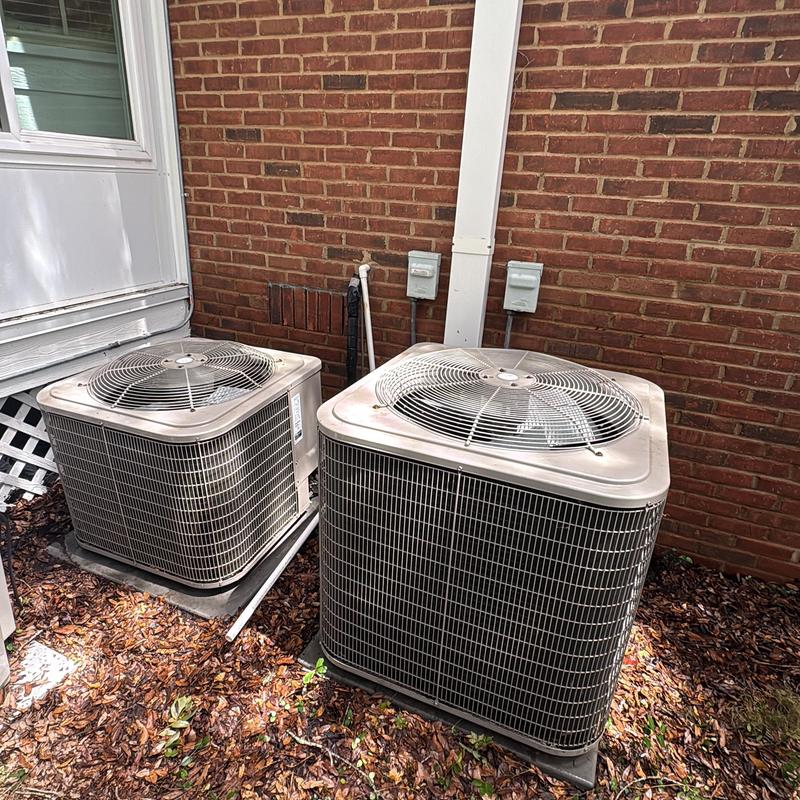 Air conditioner outdoor condenser units by brick wall Air conditioner outdoor condenser units by brick wall