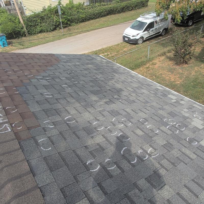 Asphalt shingle roof with marked hail damage spots