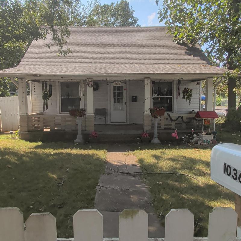 House roof and siding damage with porch view