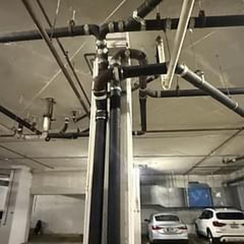Ceiling drain pipes with grease buildup and fittings