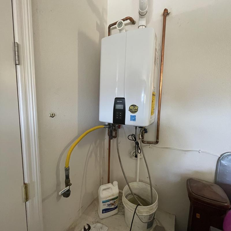 Tankless water heater with flush setup in utility room Tankless water heater with flush setup in utility room