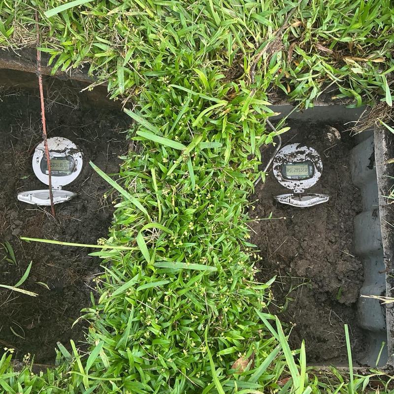 Water meters exposed in grass patch for inspection