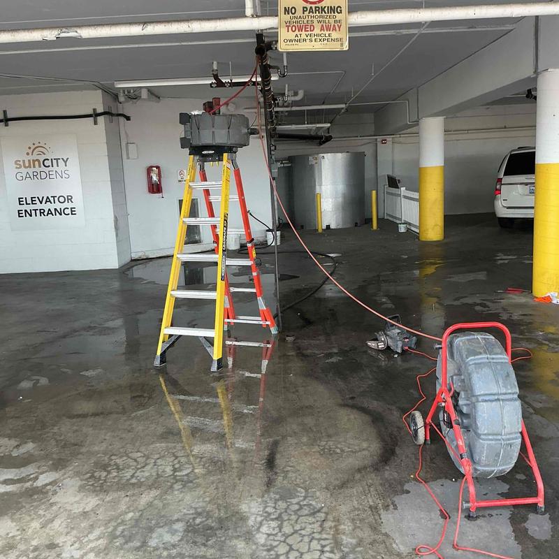 Sewer line camera inspection setup in parking garage