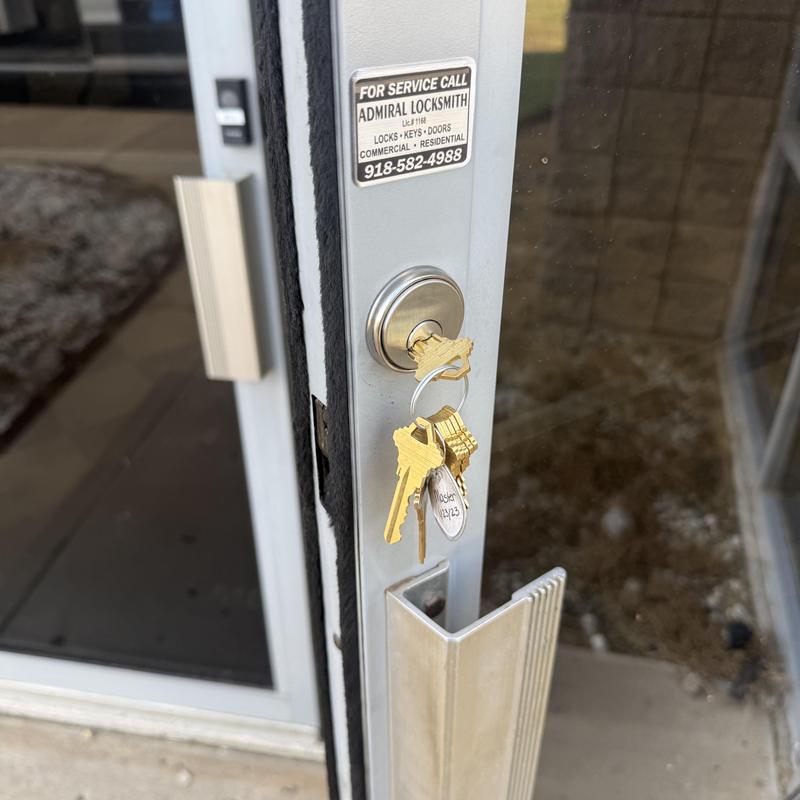 Lock cylinder with keys on commercial glass door Lock cylinder with keys on commercial glass door