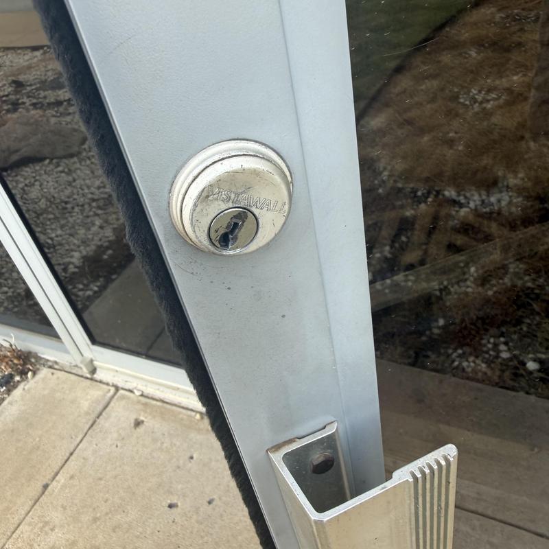 Door lock cylinder on commercial glass door Door lock cylinder on commercial glass door
