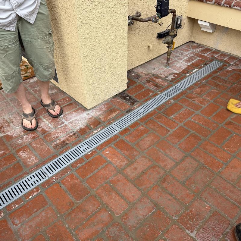 Channel drain installation with brick and concrete setting Channel drain installation with brick and concrete setting