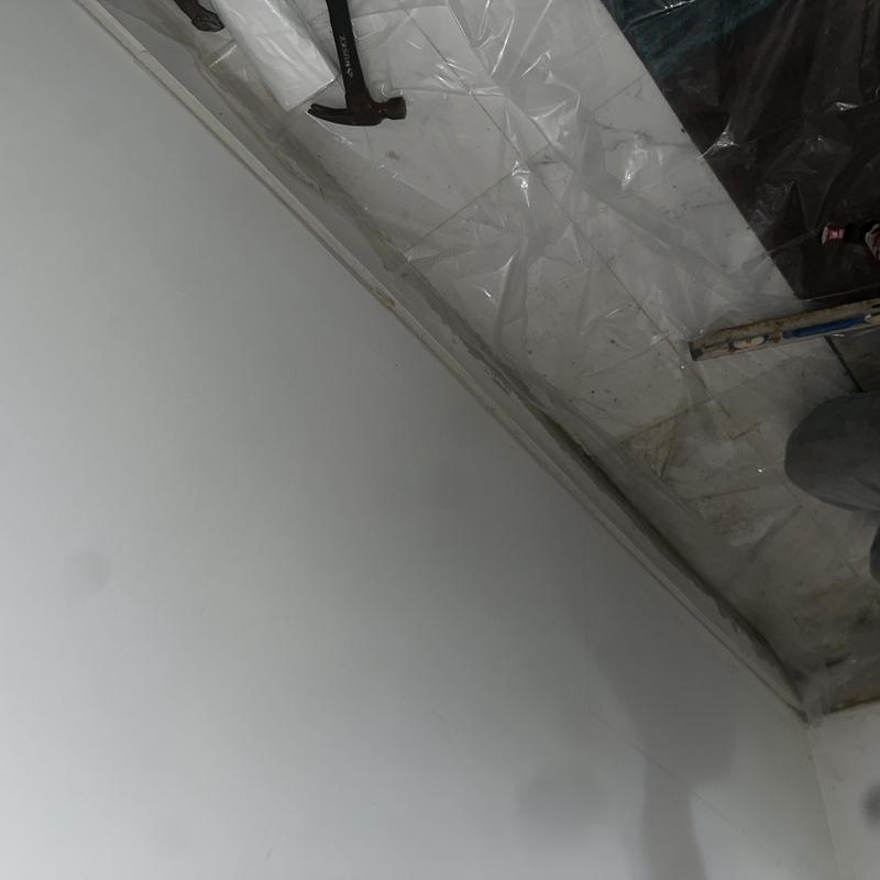 Floor leak detection setup with hammer and plastic sheeting