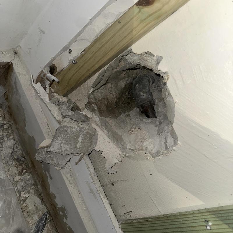 Water supply pipe leak inside wall with drywall damage