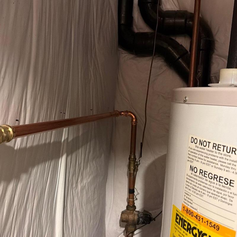 Copper piping and water heater installation in basement