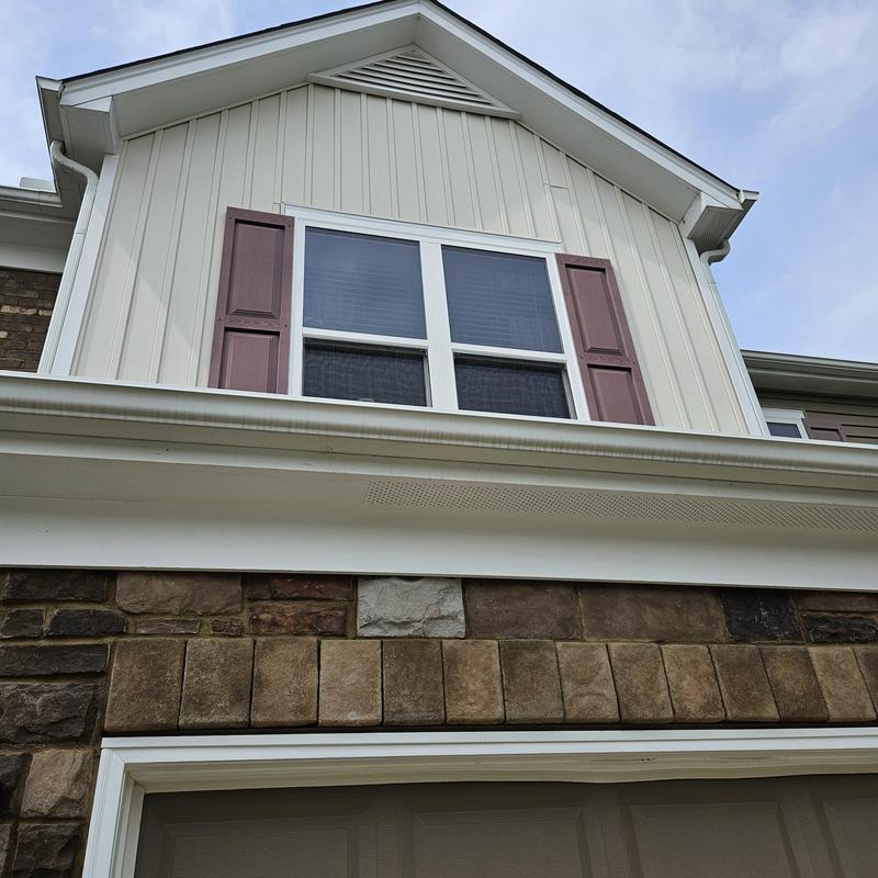Vinyl siding and stone veneer on residential house exterior