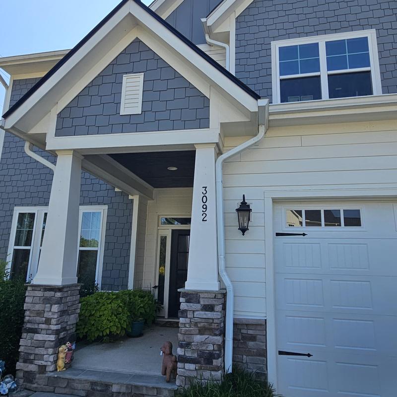 Exterior house siding with stone column porch entry