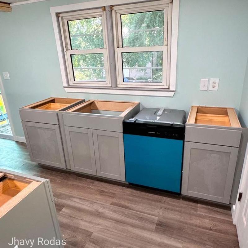Kitchen base cabinets installation near window